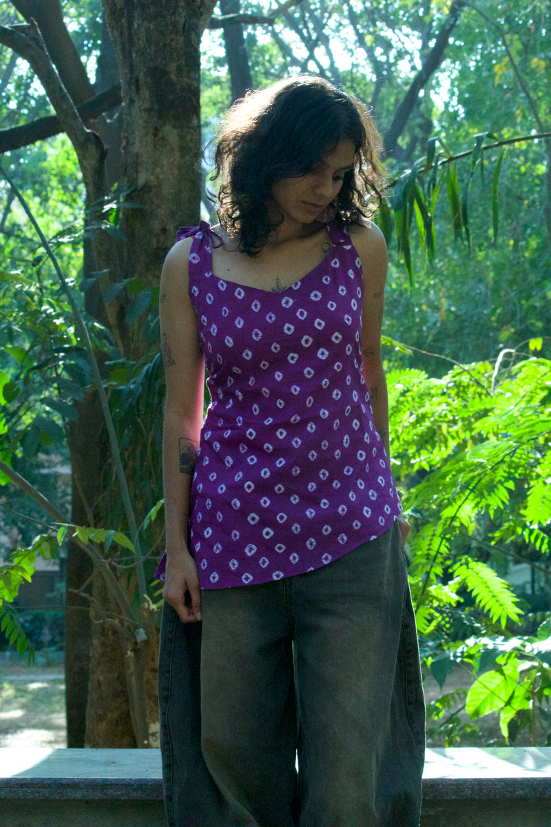 Girl standing under tree, wearing a halterneck , asymmetric bandhani kurti