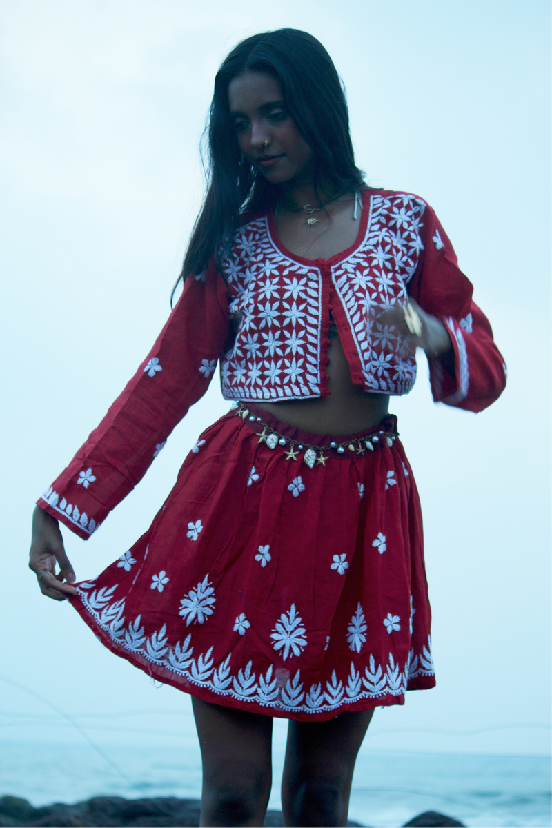 Girl standing at the beach wearing a red styled chikankari skirt top coord set